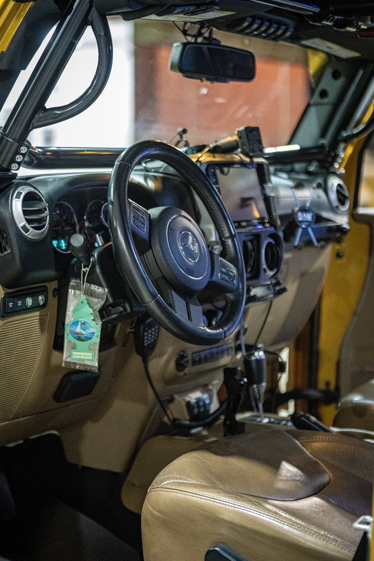 Cockpit interior with roll cage, Alpine head unit, and RAM mount