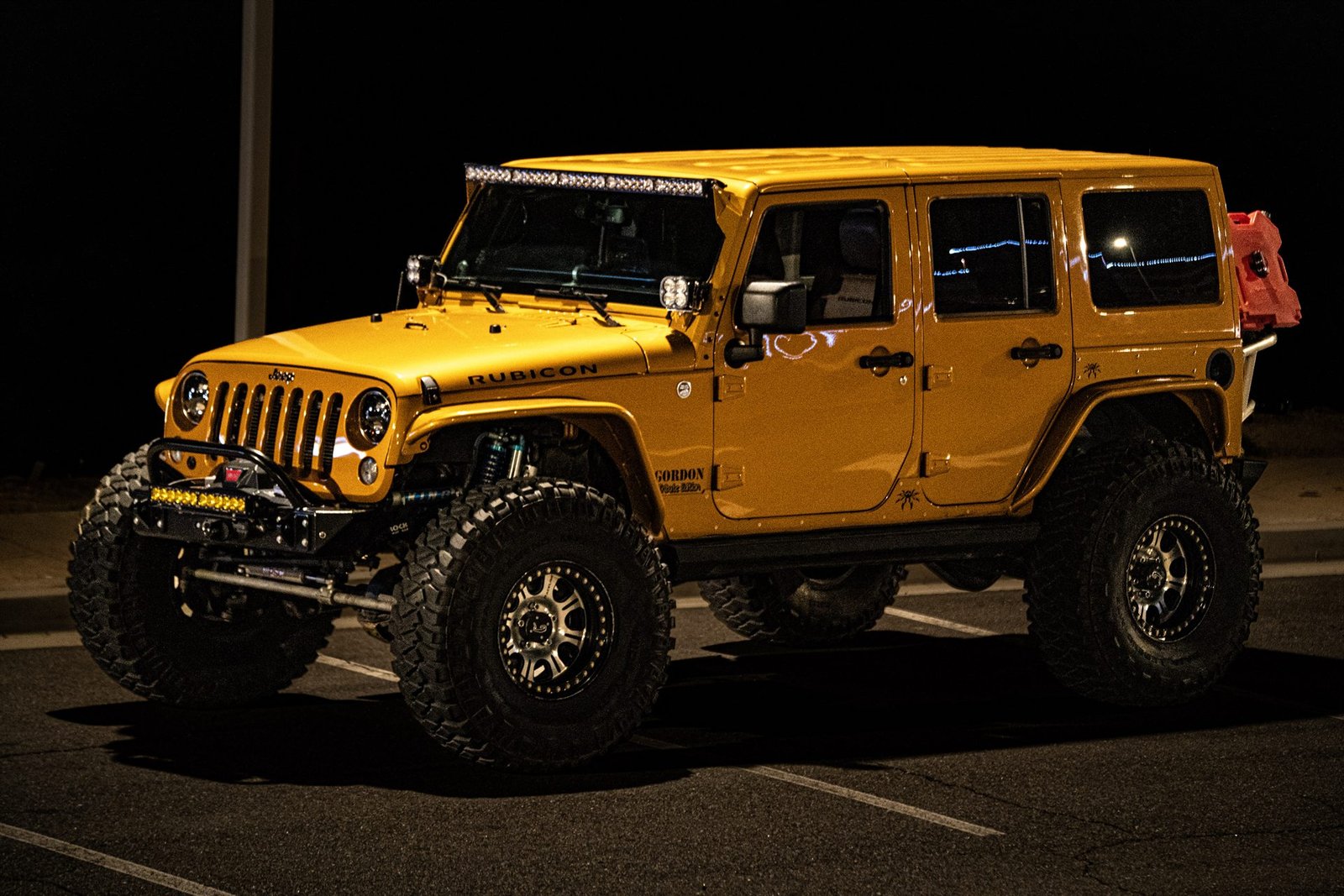 2014 Jeep Wrangler Unlimited Rubicon in Amp'd yellow with Baja Designs lighting and Warn winch