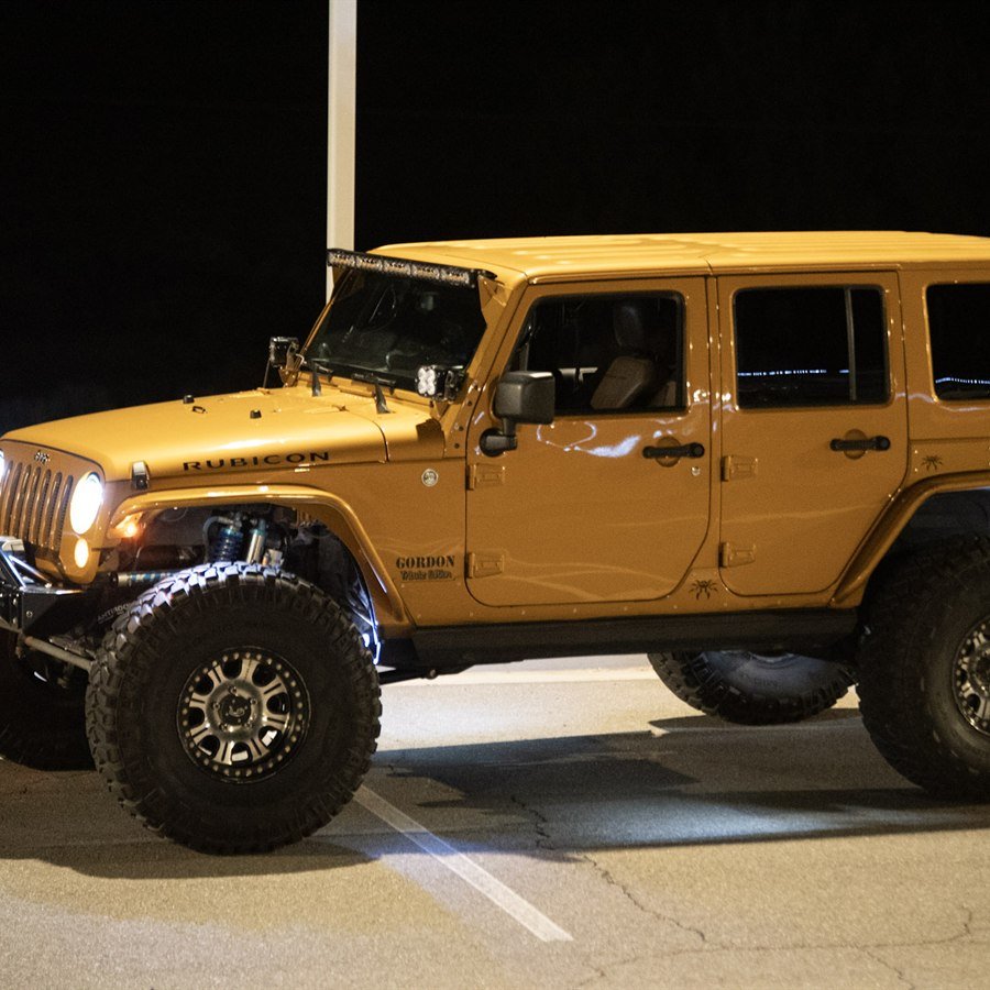 Three-quarter night view with headlights and rock lights